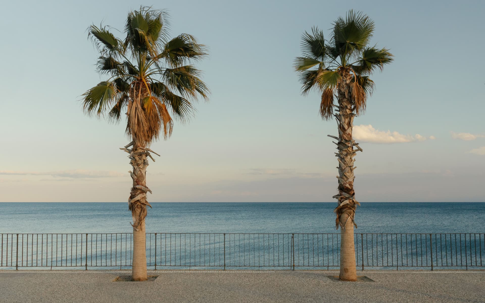 Pool overlooking a Mediterranean bay at golden hour