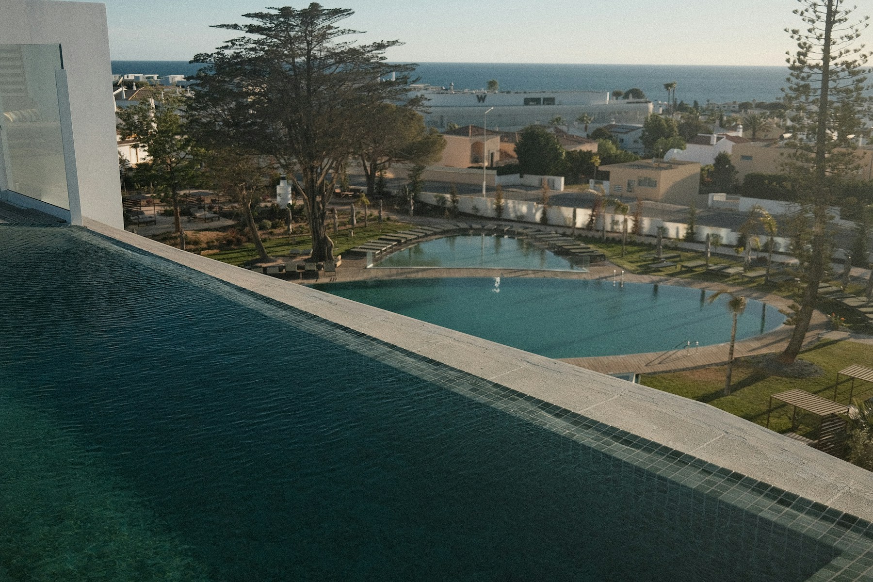 Pool overlooking a Mediterranean bay at golden hour